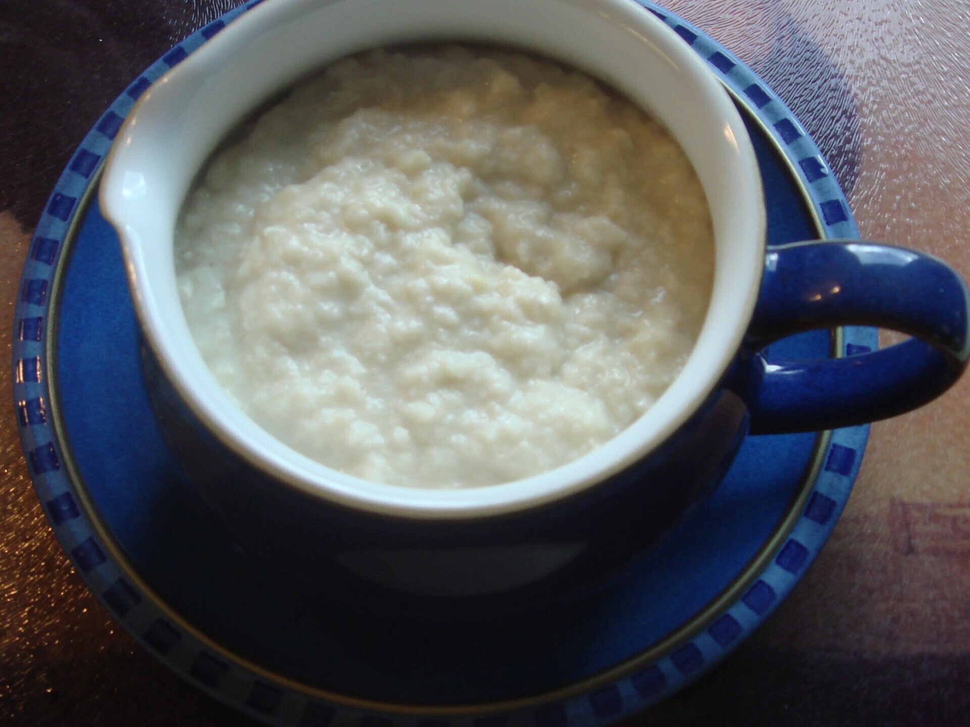 Creamy British bread sauce in a blue jug, a Jamie Oliver Christmas classic