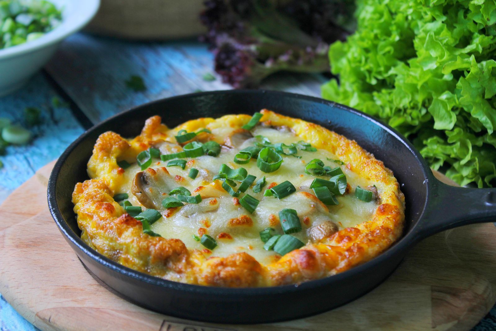 Golden baked egg and cheese dish in a cast iron pan