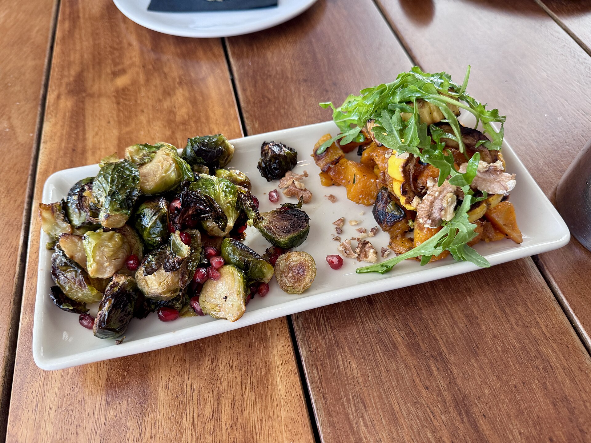 Roasted Brussels sprouts on a long white platter