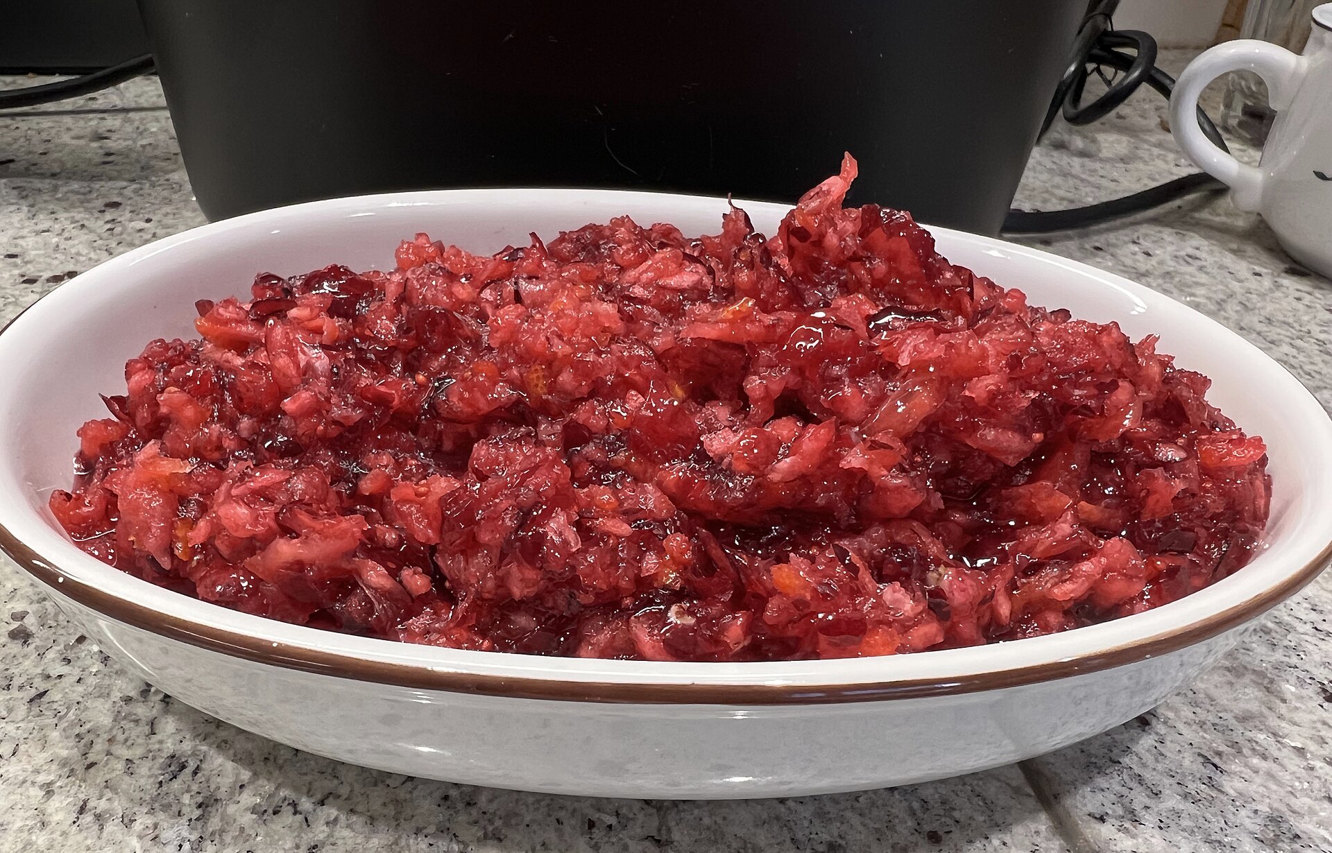 Bright red cranberry sauce in a white serving dish