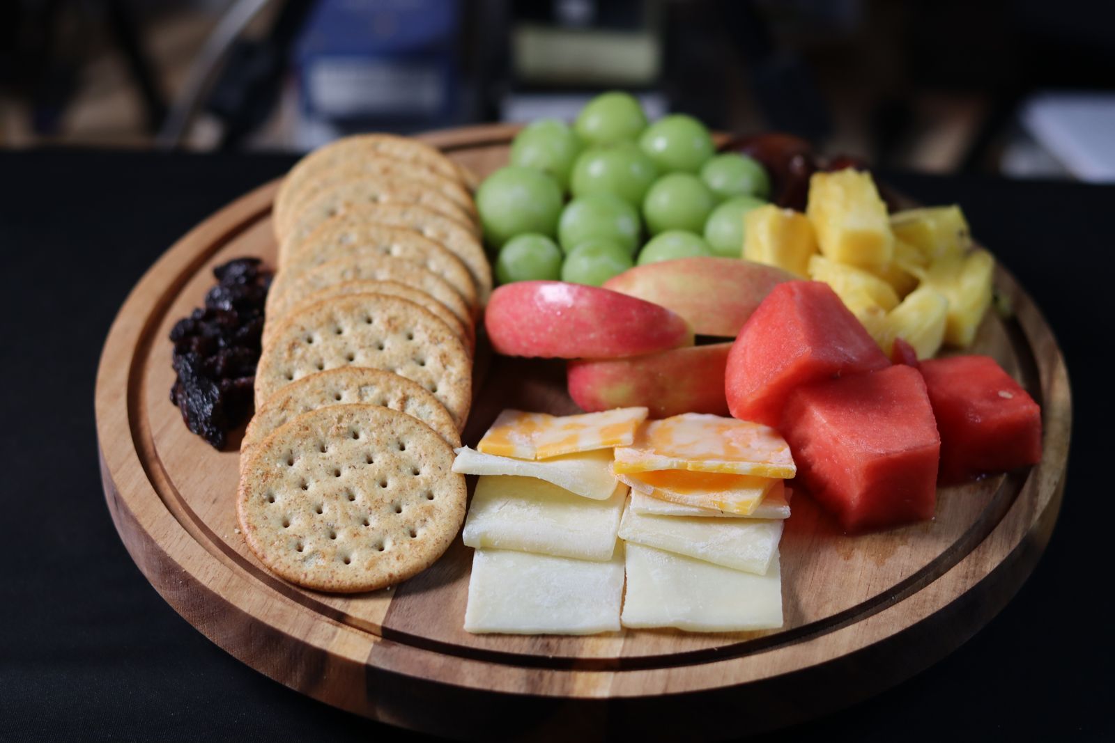 Kids table snack board with crackers, cheese and fresh fruit