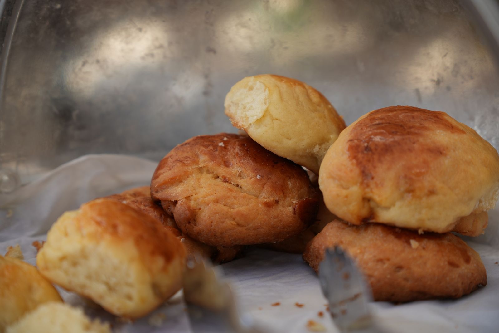 Soft golden homemade dinner rolls in a basket