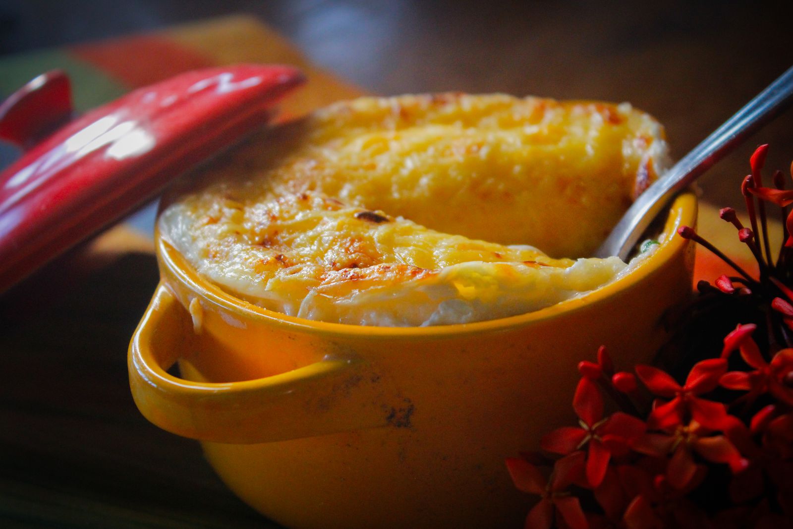 Cheesy baked corn casserole in a yellow pot