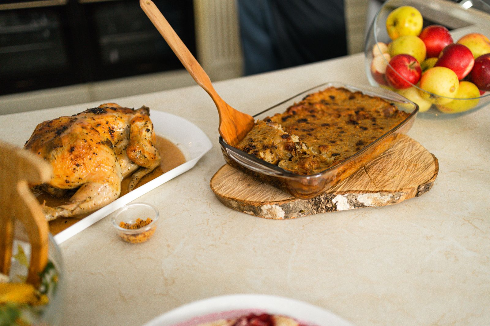 Pan of cornbread dressing next to a roast bird, a must for Texas Thanksgiving recipes