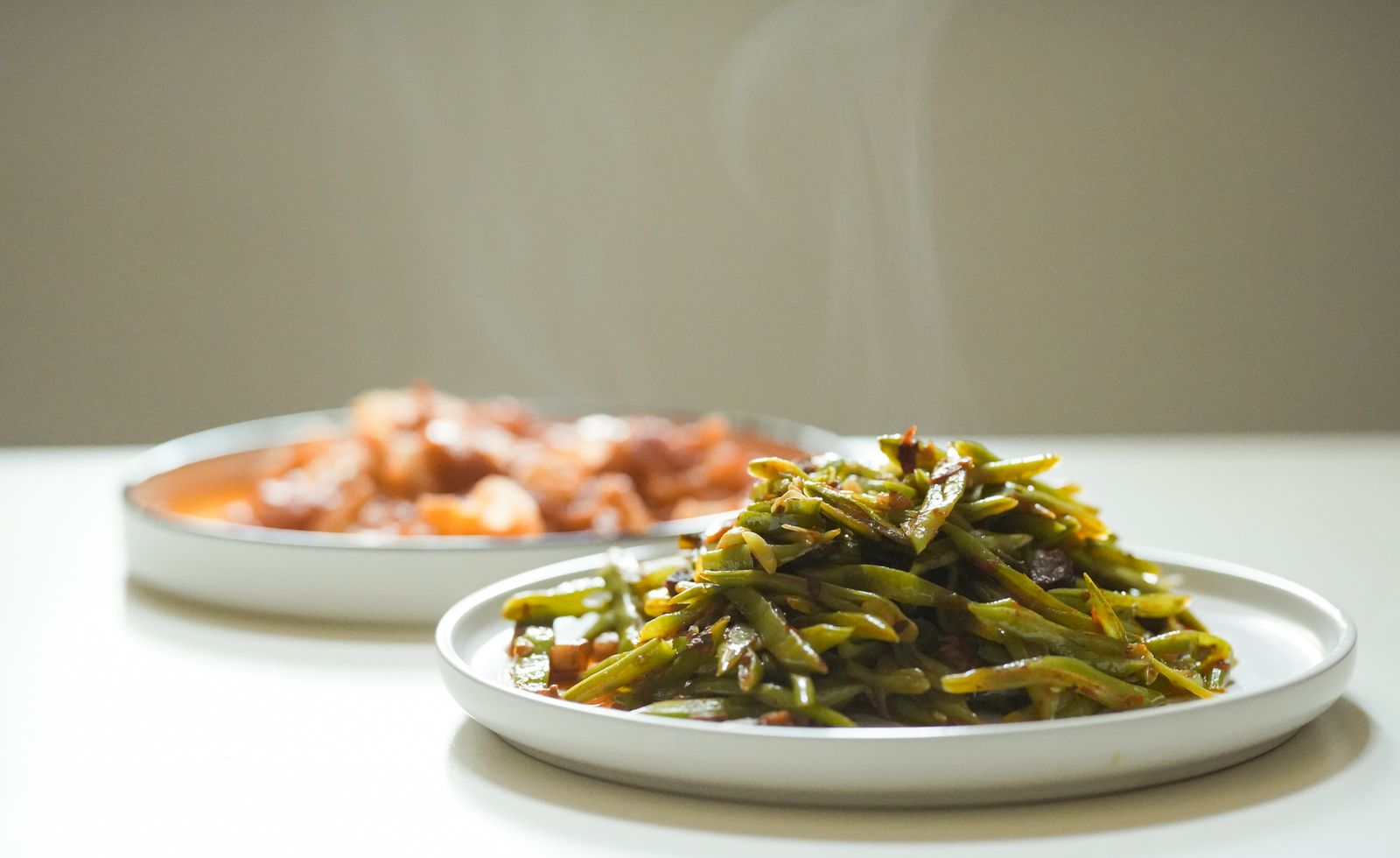 Plate of Southern green beans cooked with bacon, a side for Texas Thanksgiving recipes