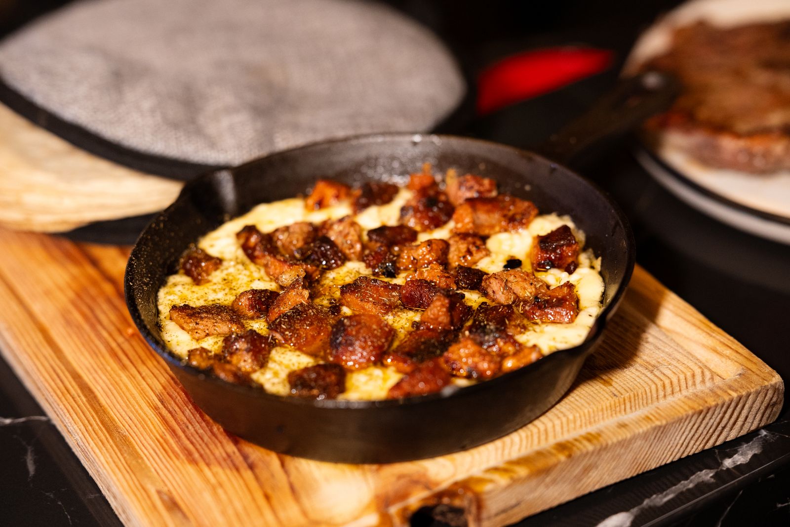 Hot skillet of melted cheese dip with chorizo for the game