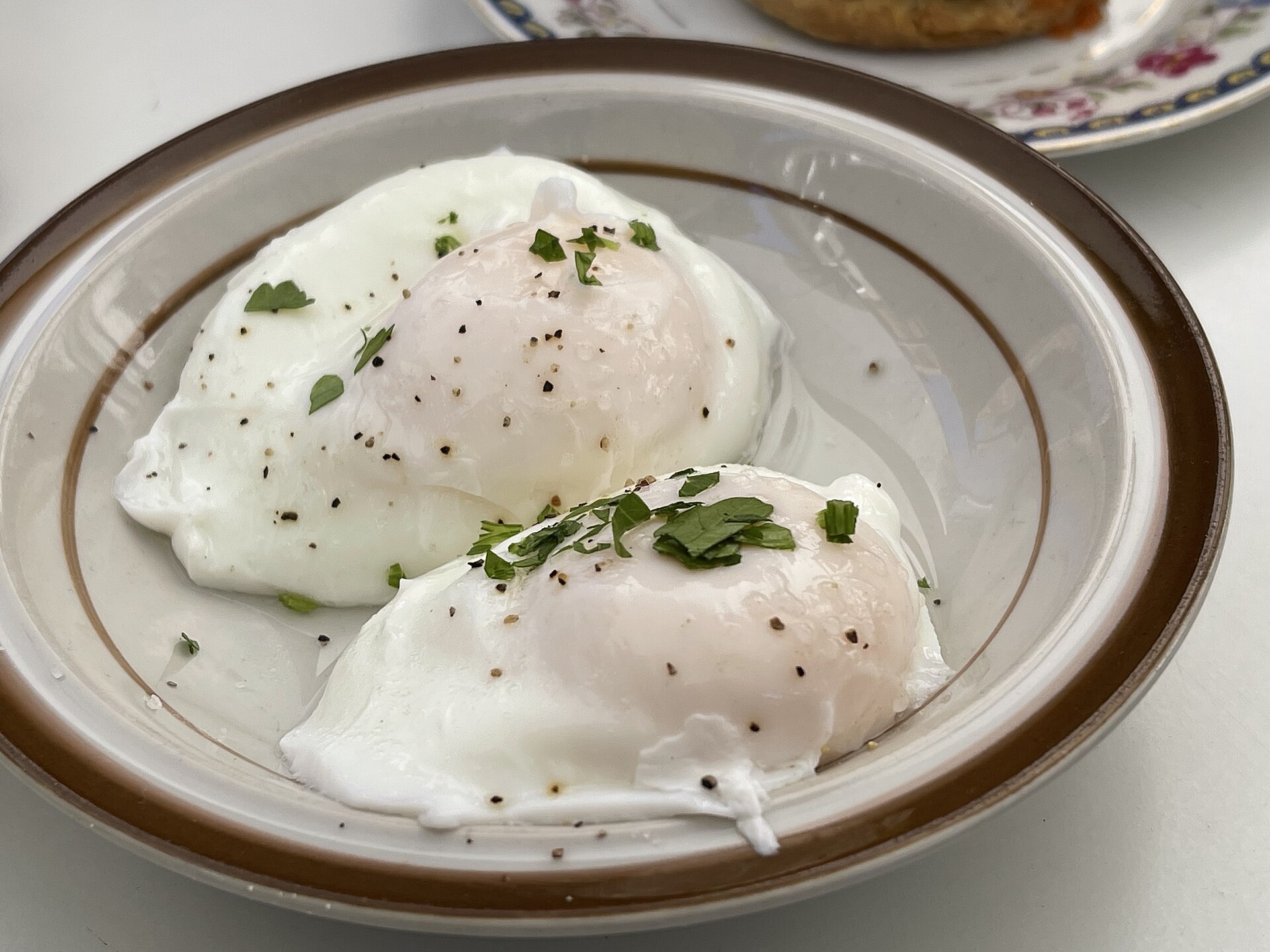 Two soft poached eggs in a bowl