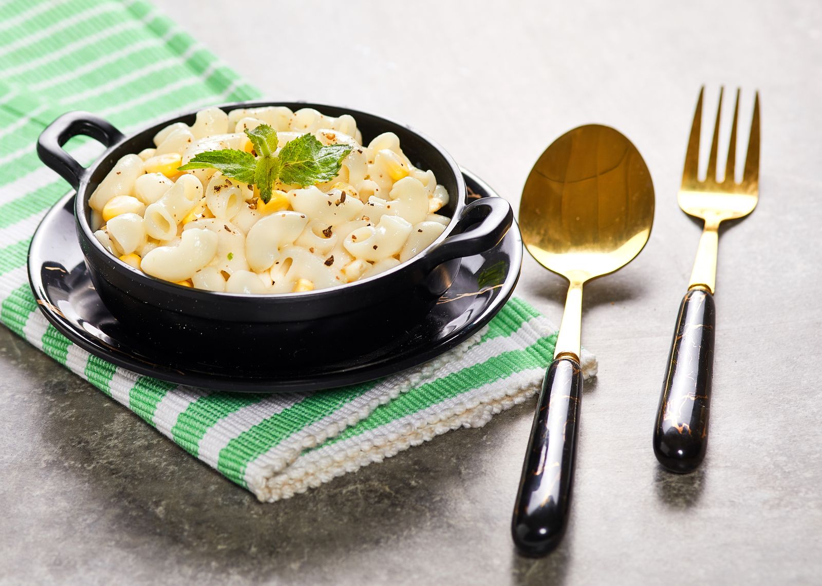 Creamy macaroni and cheese in a small black dish