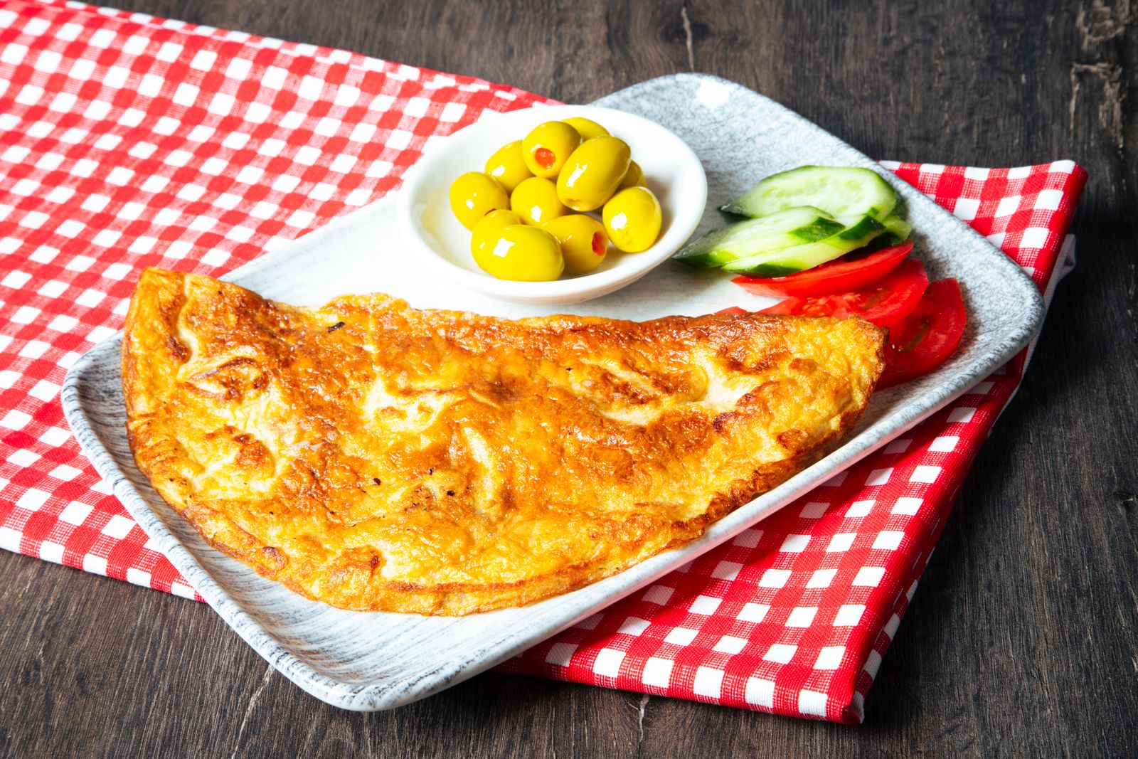 Golden French omelet on a plate, the most famous of all Jacques Pepin recipes