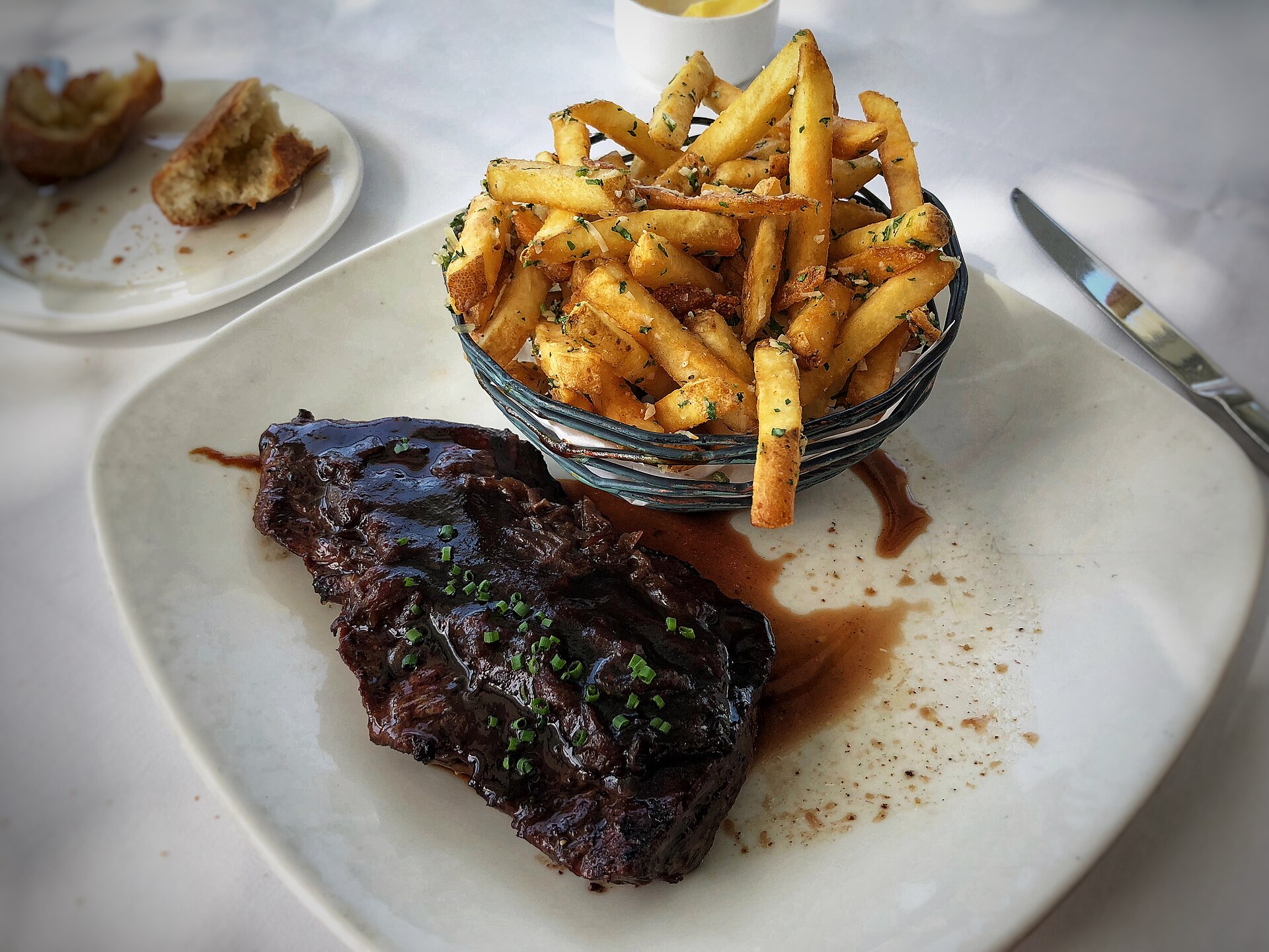 Pan seared steak with a basket of French fries