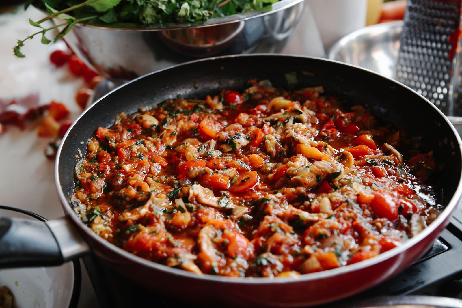 Pan of chunky vegetable stew simmering on the stove