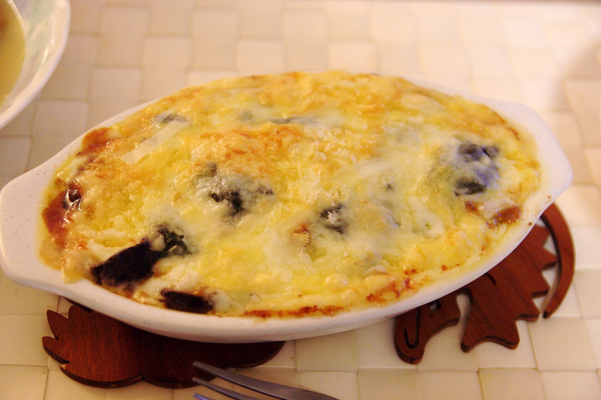 Cheesy eggplant gratin baked in an oval dish