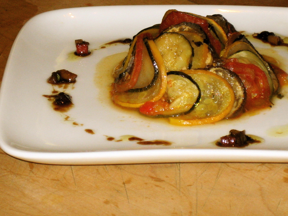 Restaurant-style fan of thin vegetable slices on a white plate, as in the movie
