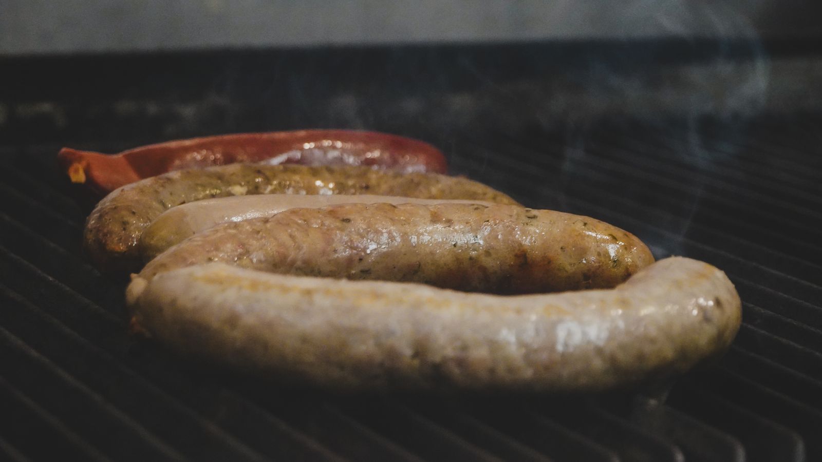 Smoked sausages browning, ready to slice into the pot