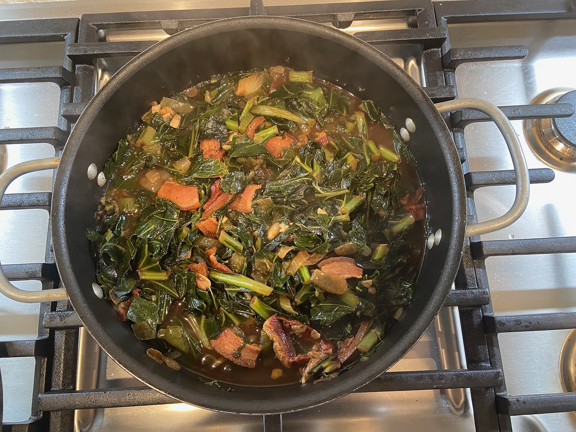 Pot of Southern collard greens cooking on the stove