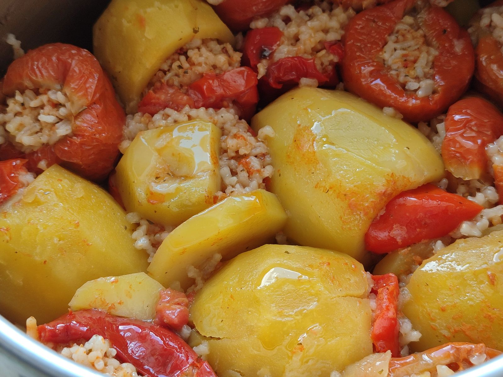 Stuffed peppers and tomatoes baked in a pan