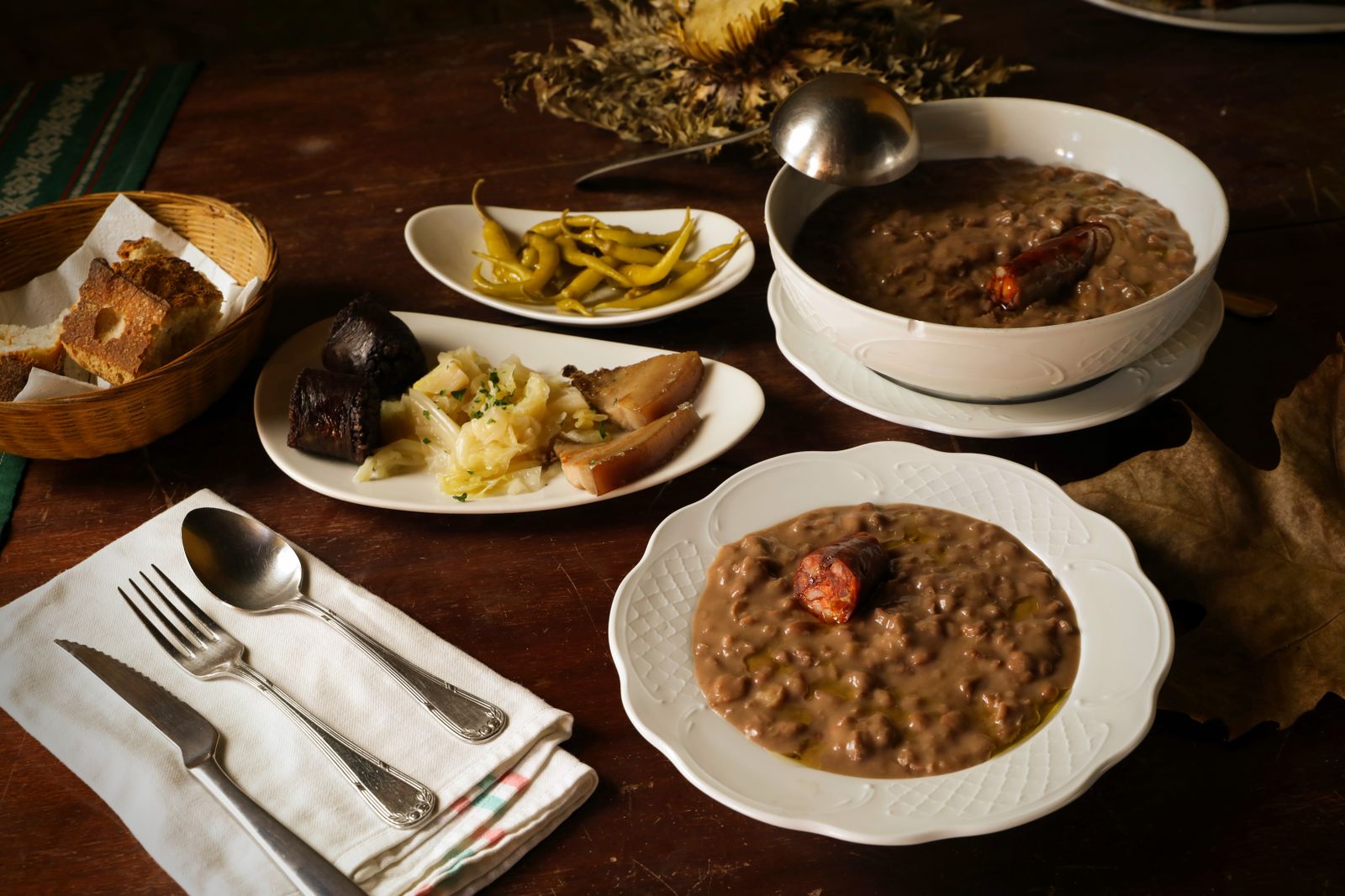 Bowls of rustic bean soup with sausage and bread