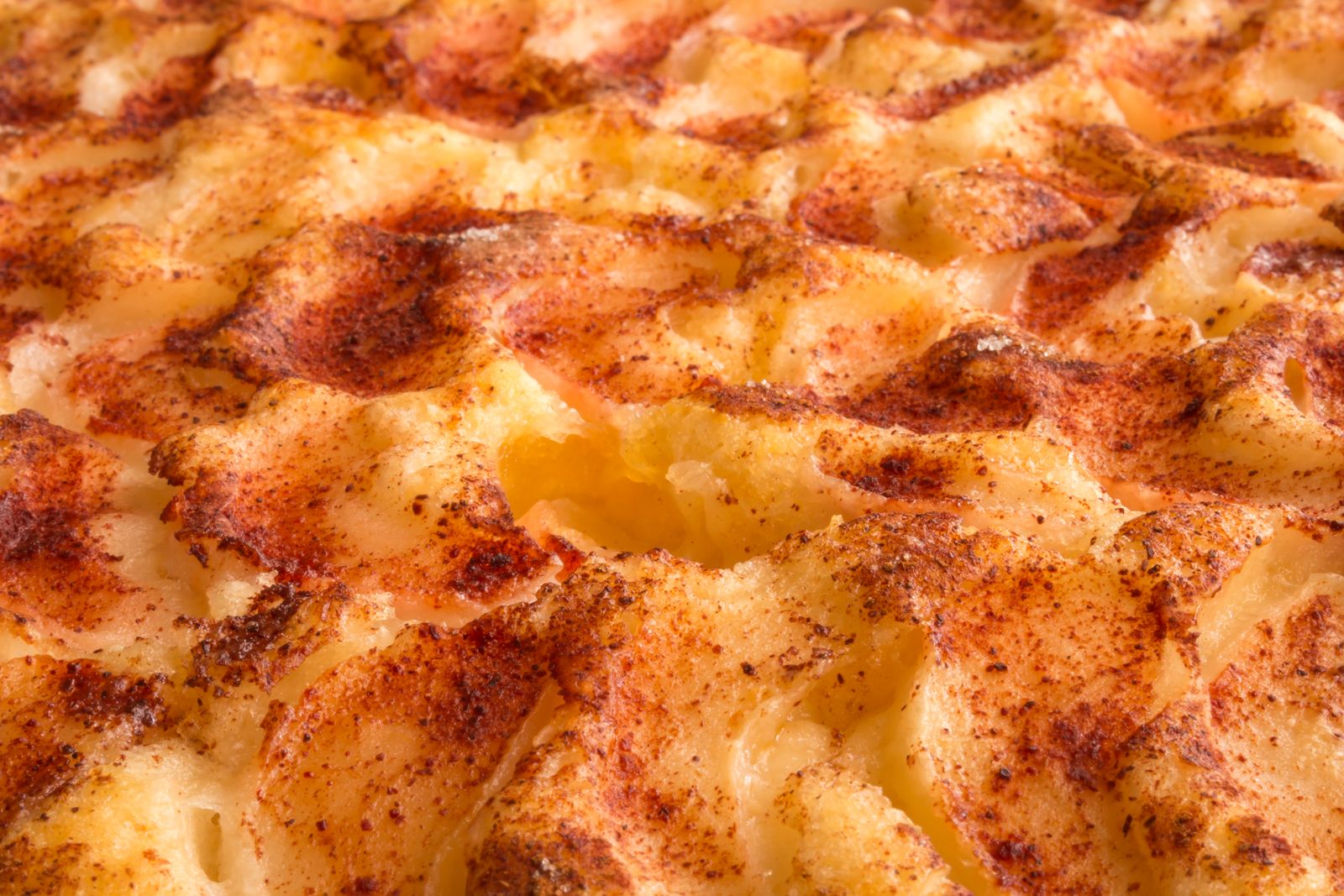 Close up of a golden browned mashed potato topping with crisp ridges