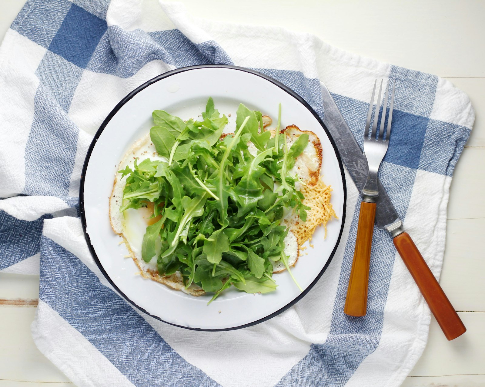 Simple green salad served on a white plate