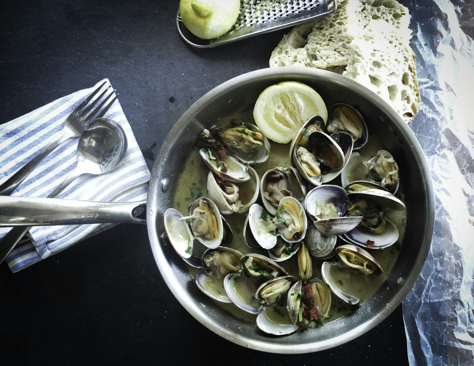 Clams simmering in a steel pan, the Patsy's favorite among Frank Sinatra recipes