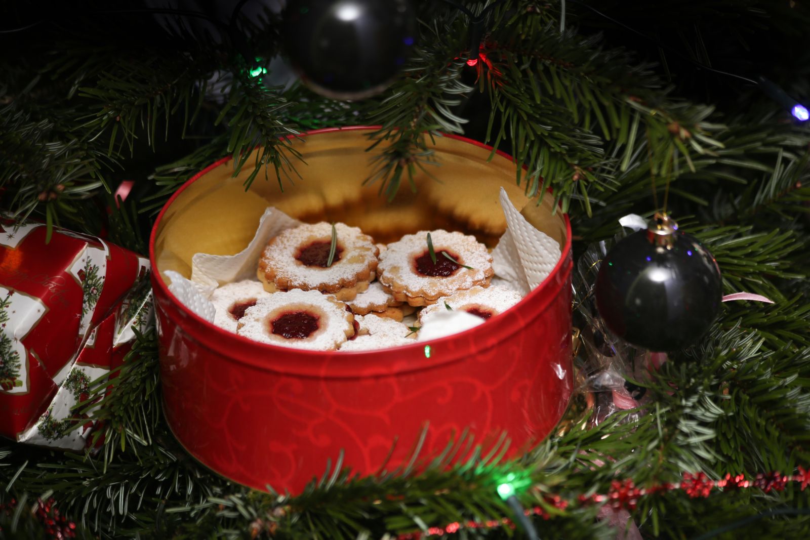Red Christmas tin filled with homemade holiday treats for gifting