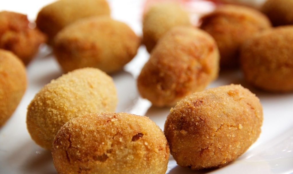Golden ham croquettes on a white plate