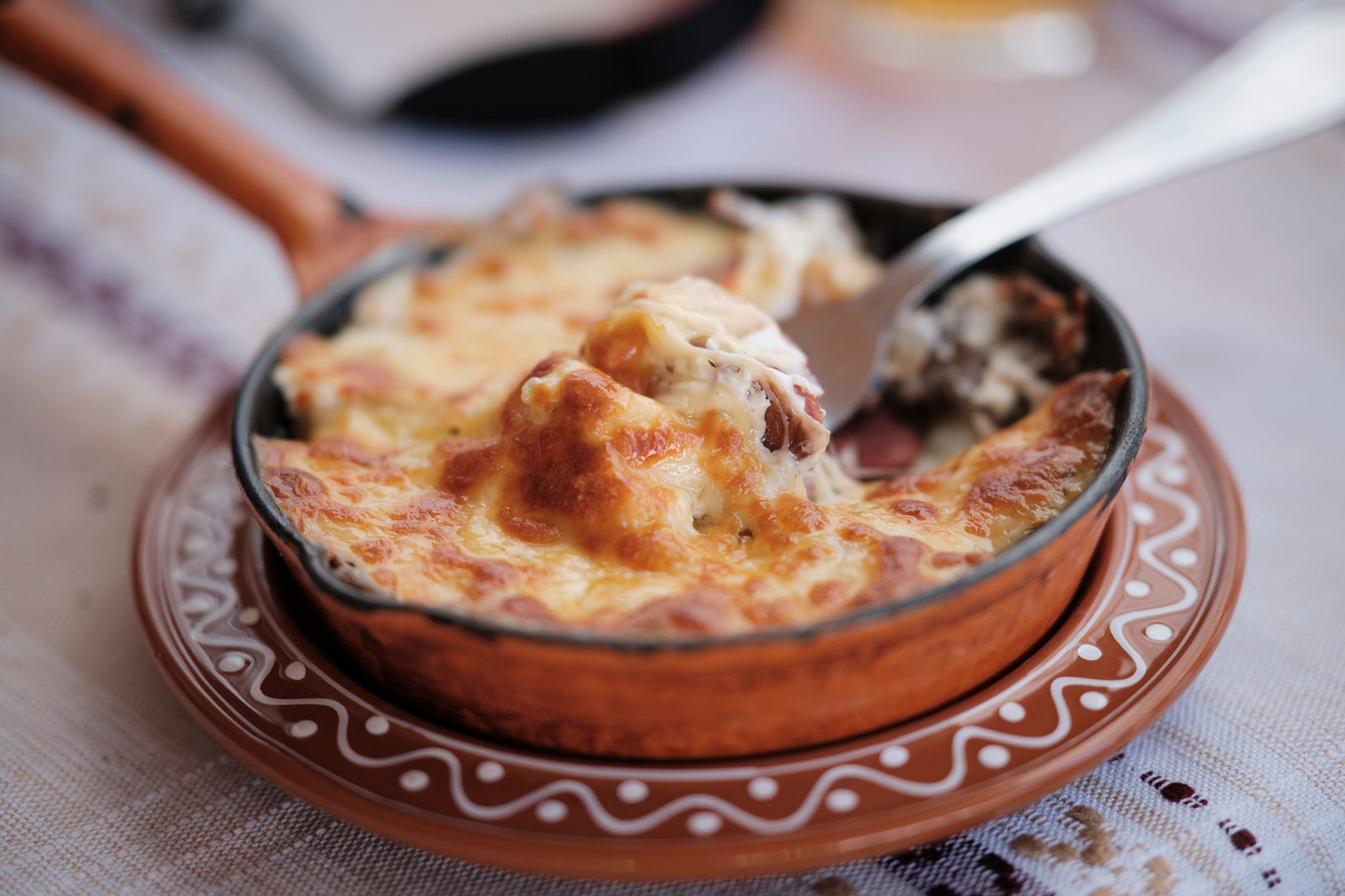 Cheesy baked pasta with a golden crust in a round dish