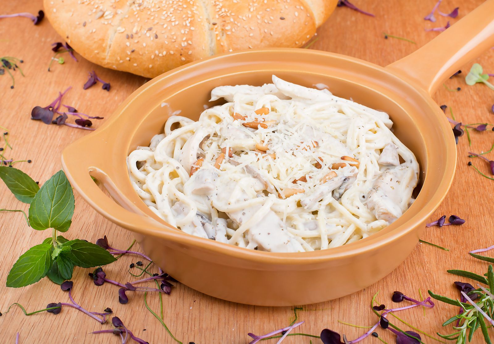 Creamy spaghetti in a tan baking dish, a rotisserie chicken take on Tetrazzini recipes