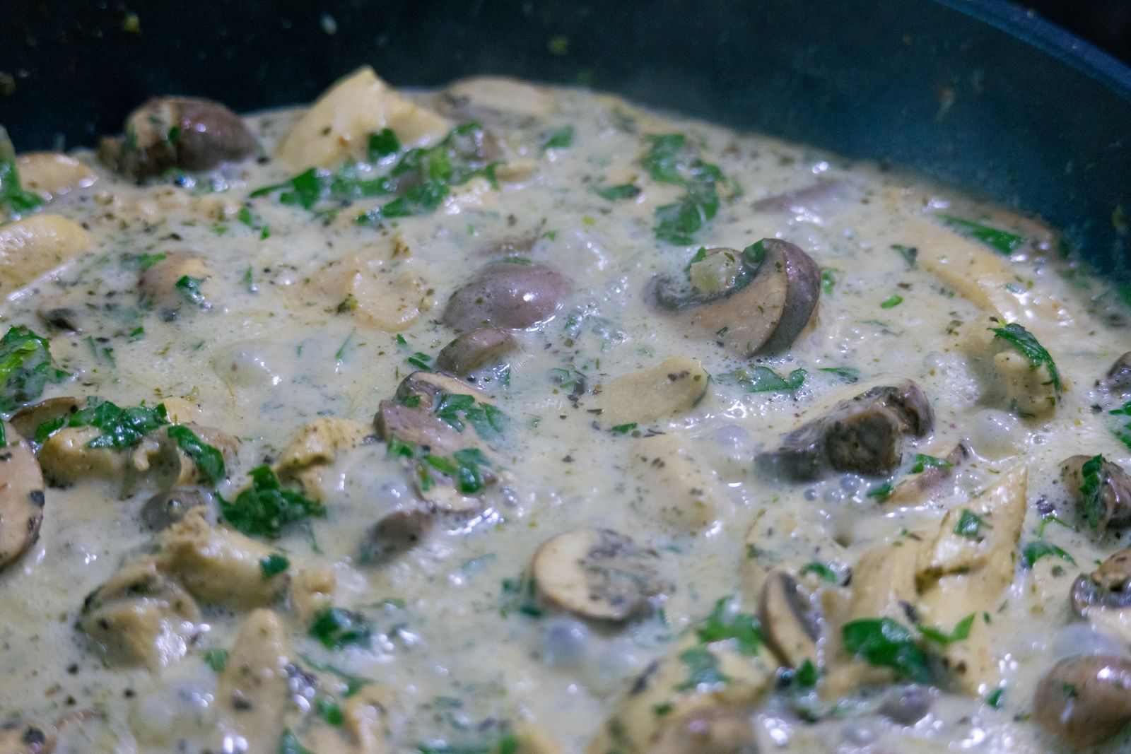 Creamy mushroom sauce simmering in a pan