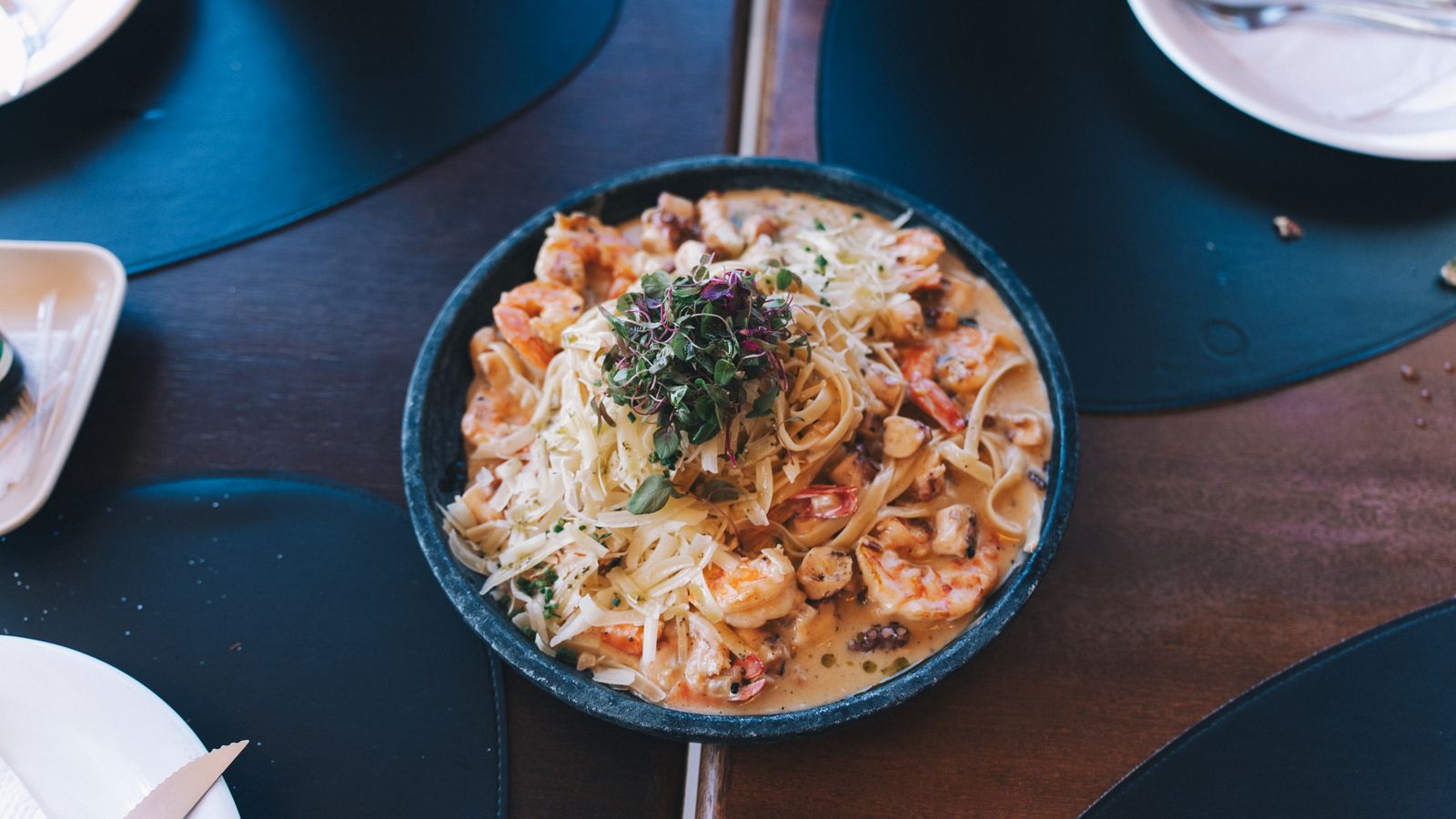 Creamy shrimp pasta in a blue bowl, one of the seafood Tetrazzini recipes