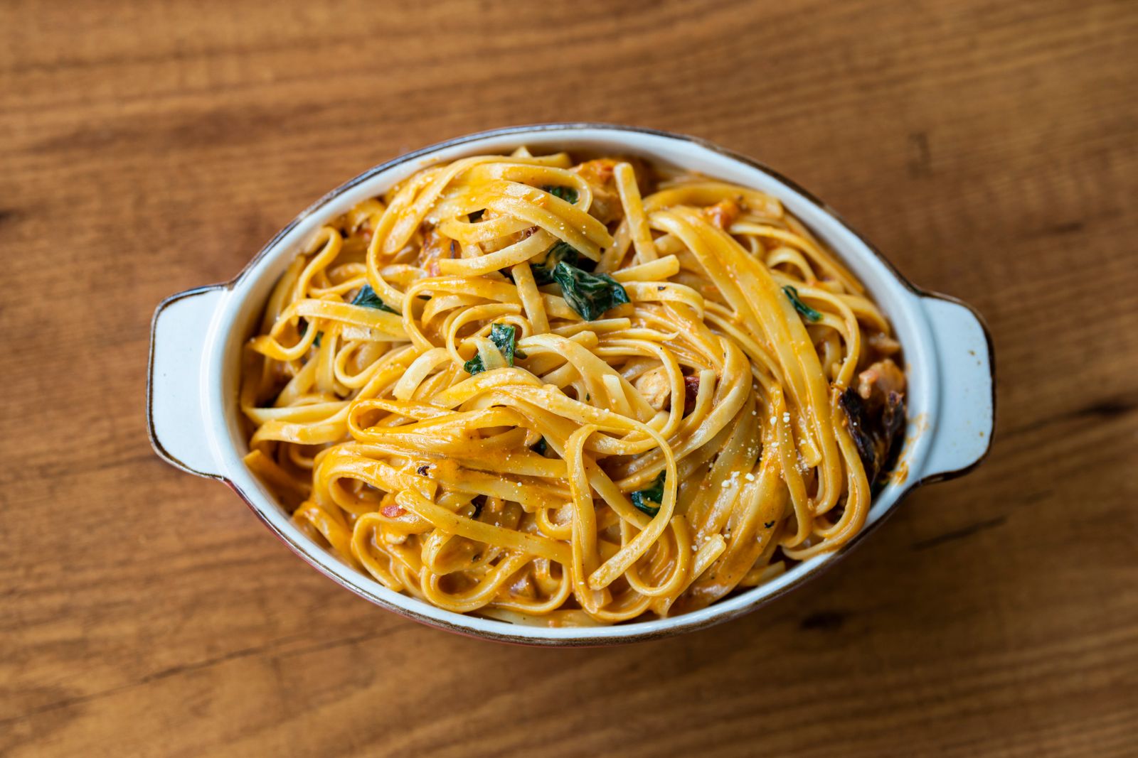 Spaghetti with spinach in an oval baking dish, a meatless idea for Tetrazzini recipes