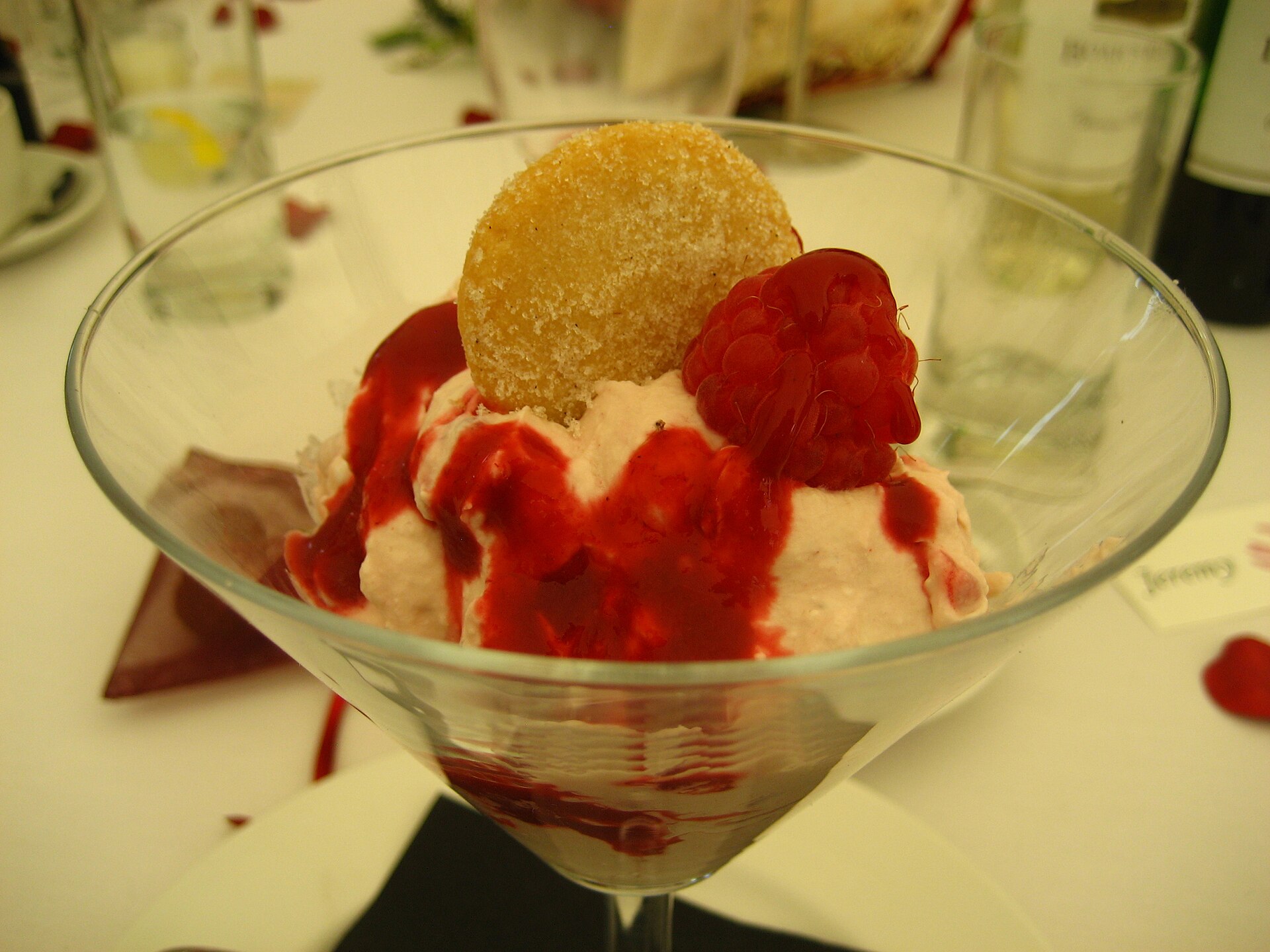 Eton mess with cream, raspberries and a crisp cookie in a glass, a light holiday party food dessert