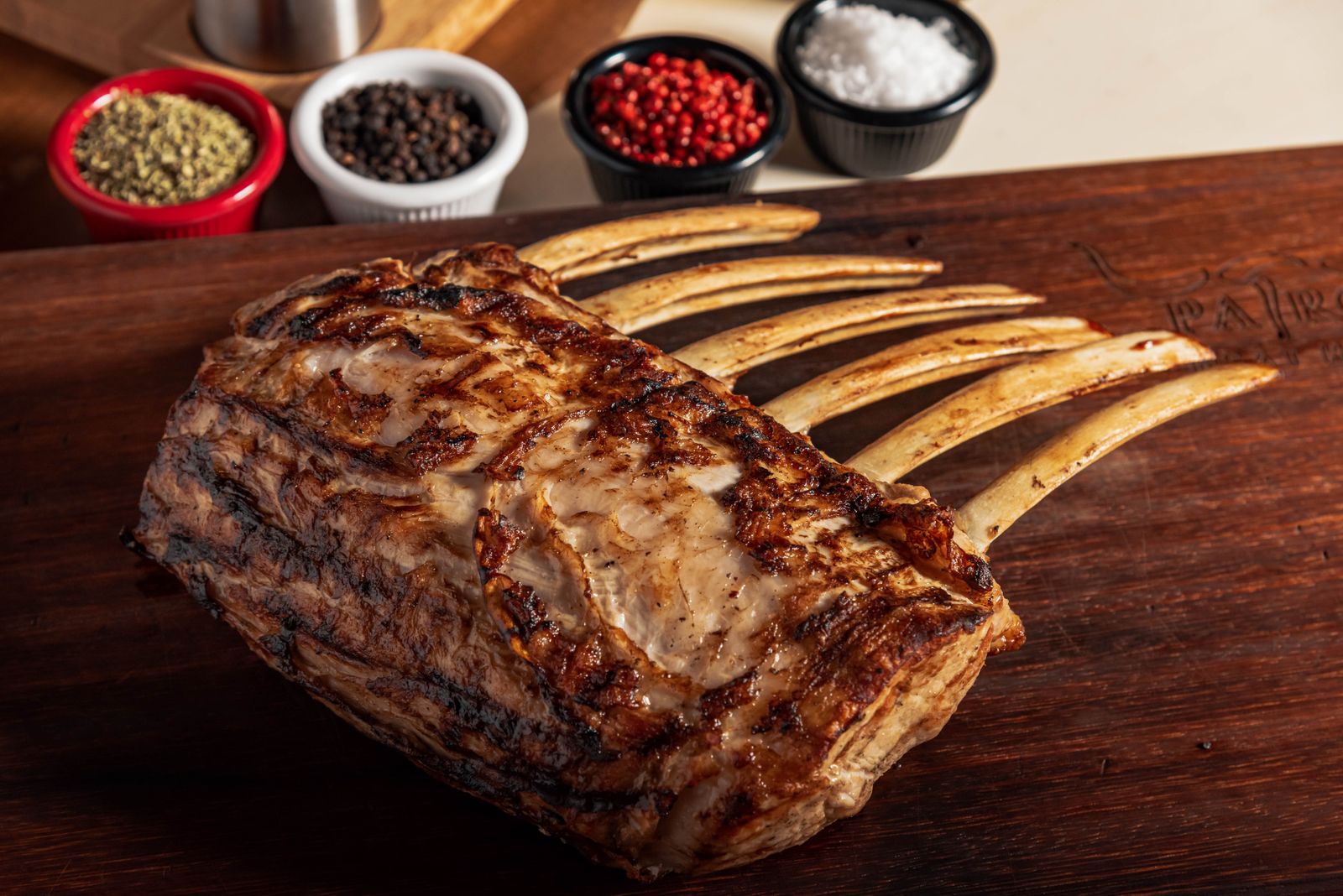 Roasted rack of lamb on a wooden board for a small dinner party