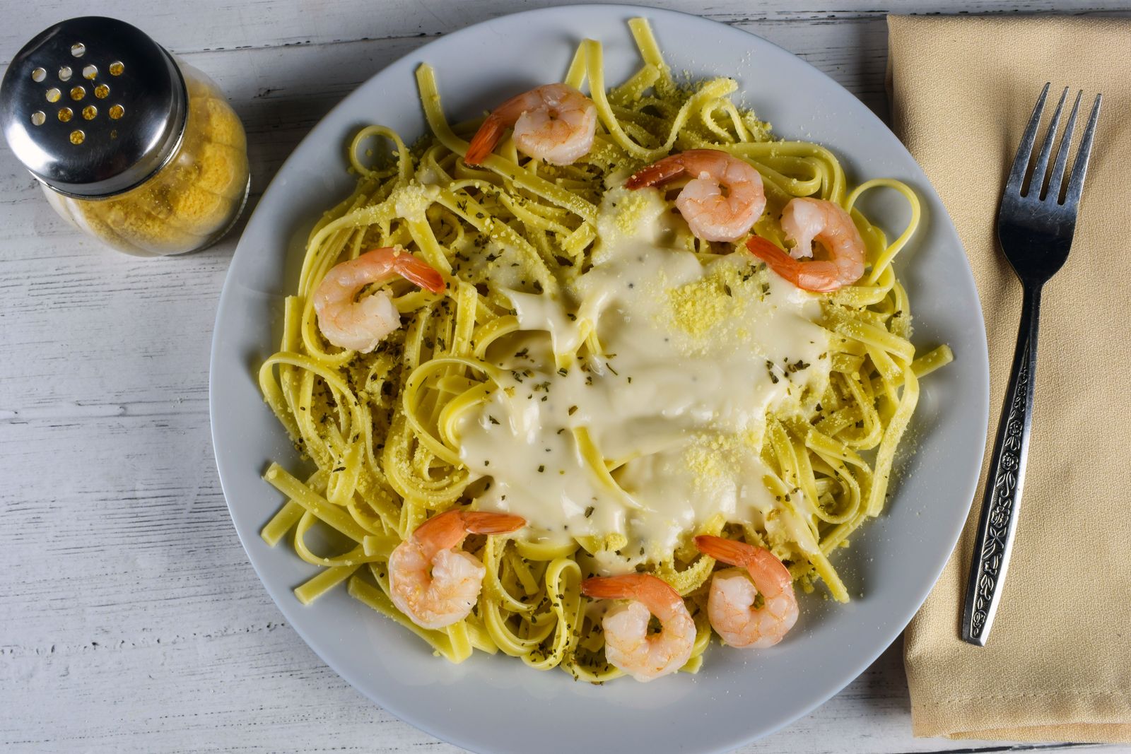 Garlic shrimp linguine on a gray plate, easy holiday party food for a crowd
