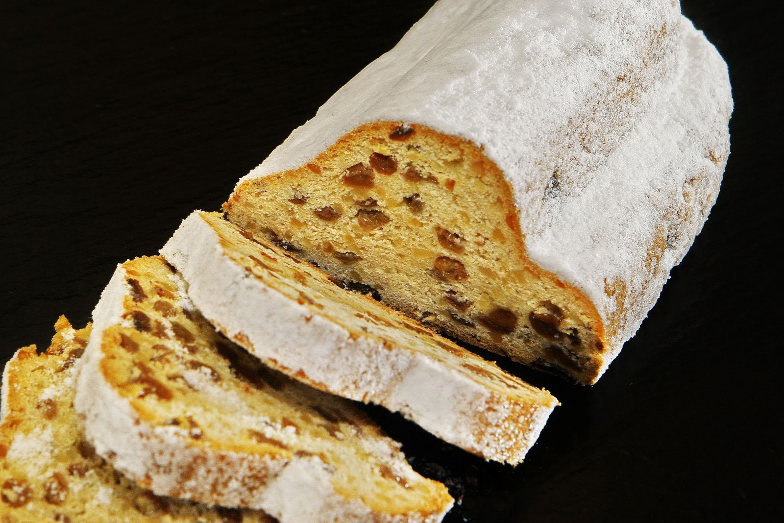 Sliced stollen fruit bread with powdered sugar