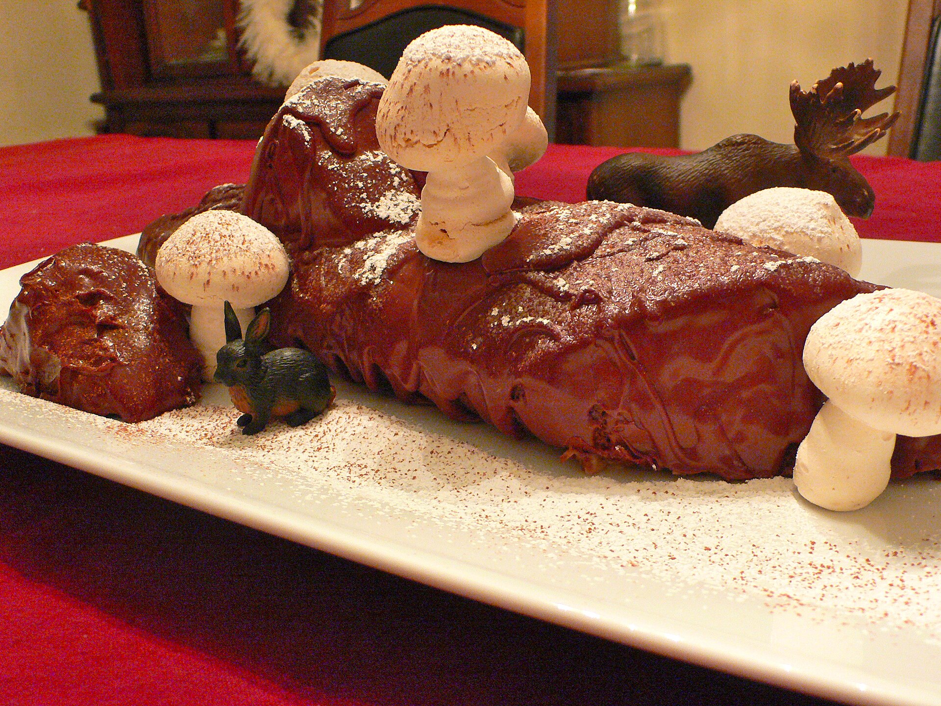Chocolate Yule log decorated with meringue mushrooms