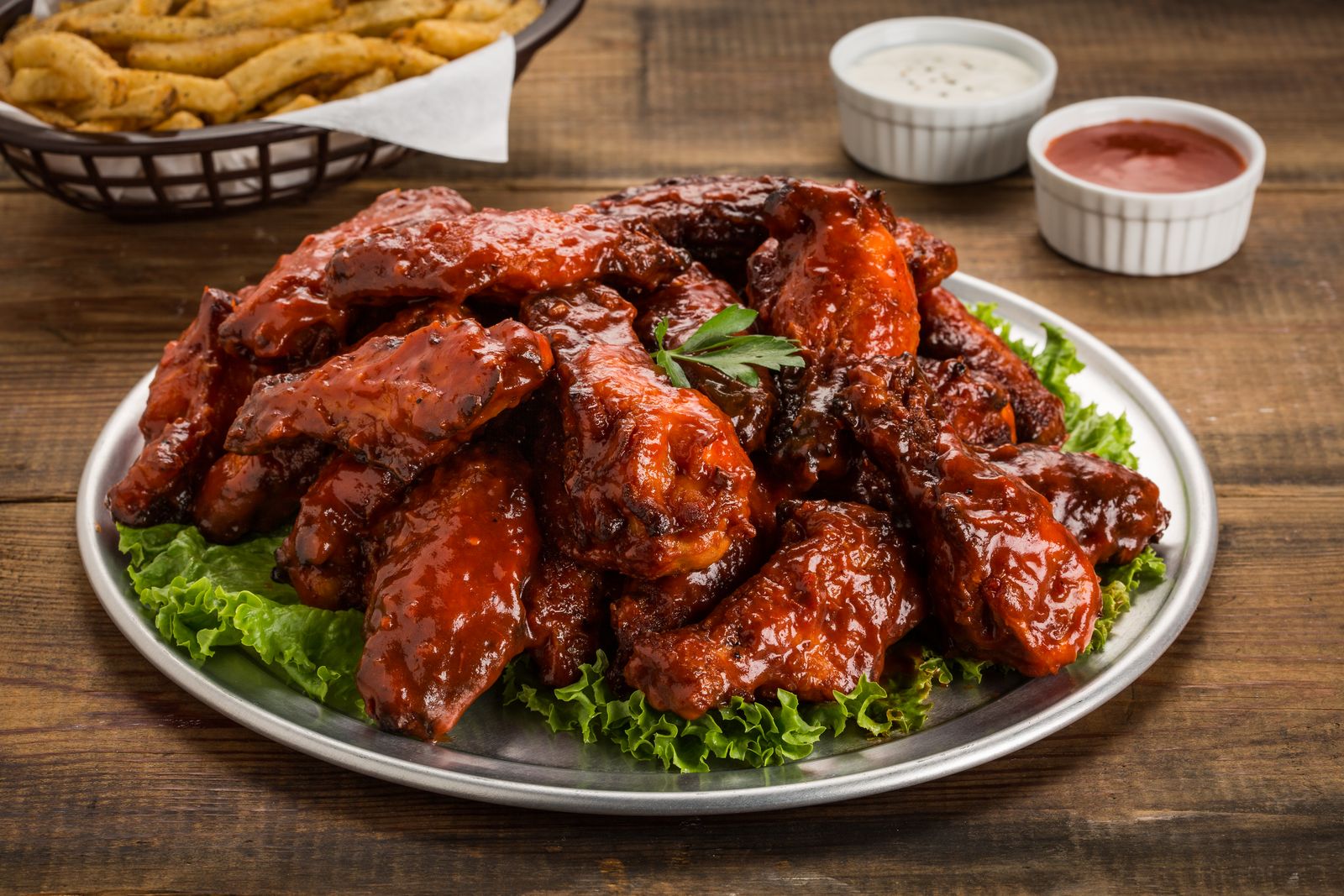 Chicken wings glazed with homemade barbecue sauce and dips
