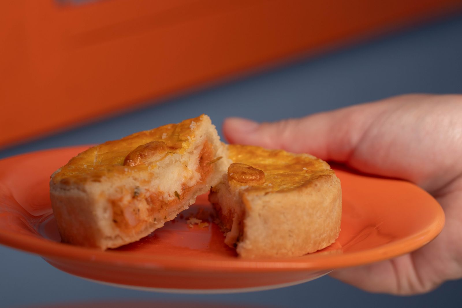Golden homemade hand pie on an orange plate