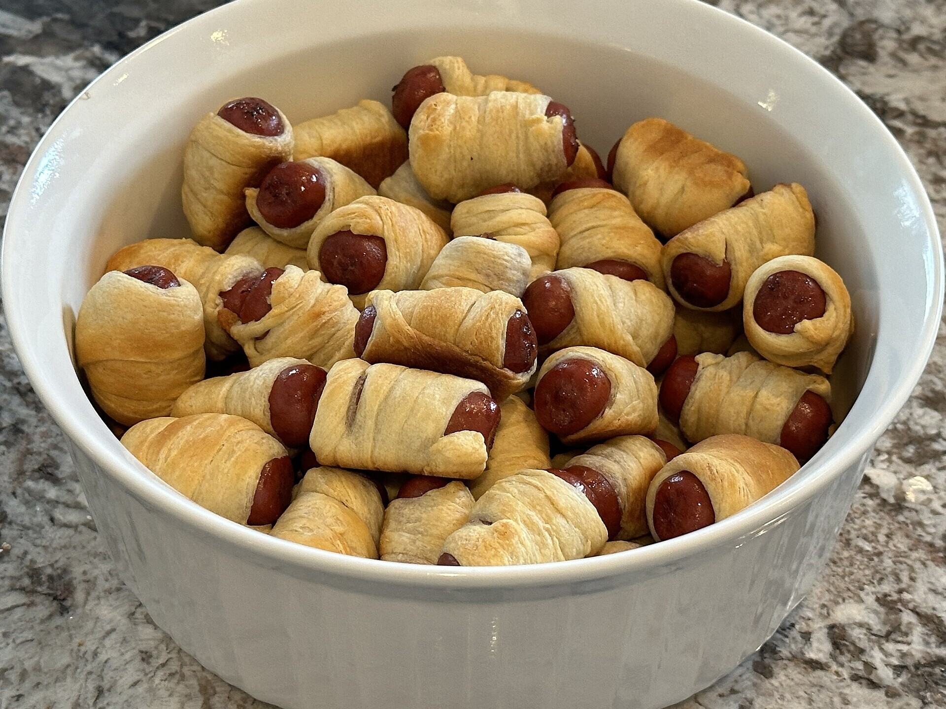 Bowl of pastry wrapped mini sausages