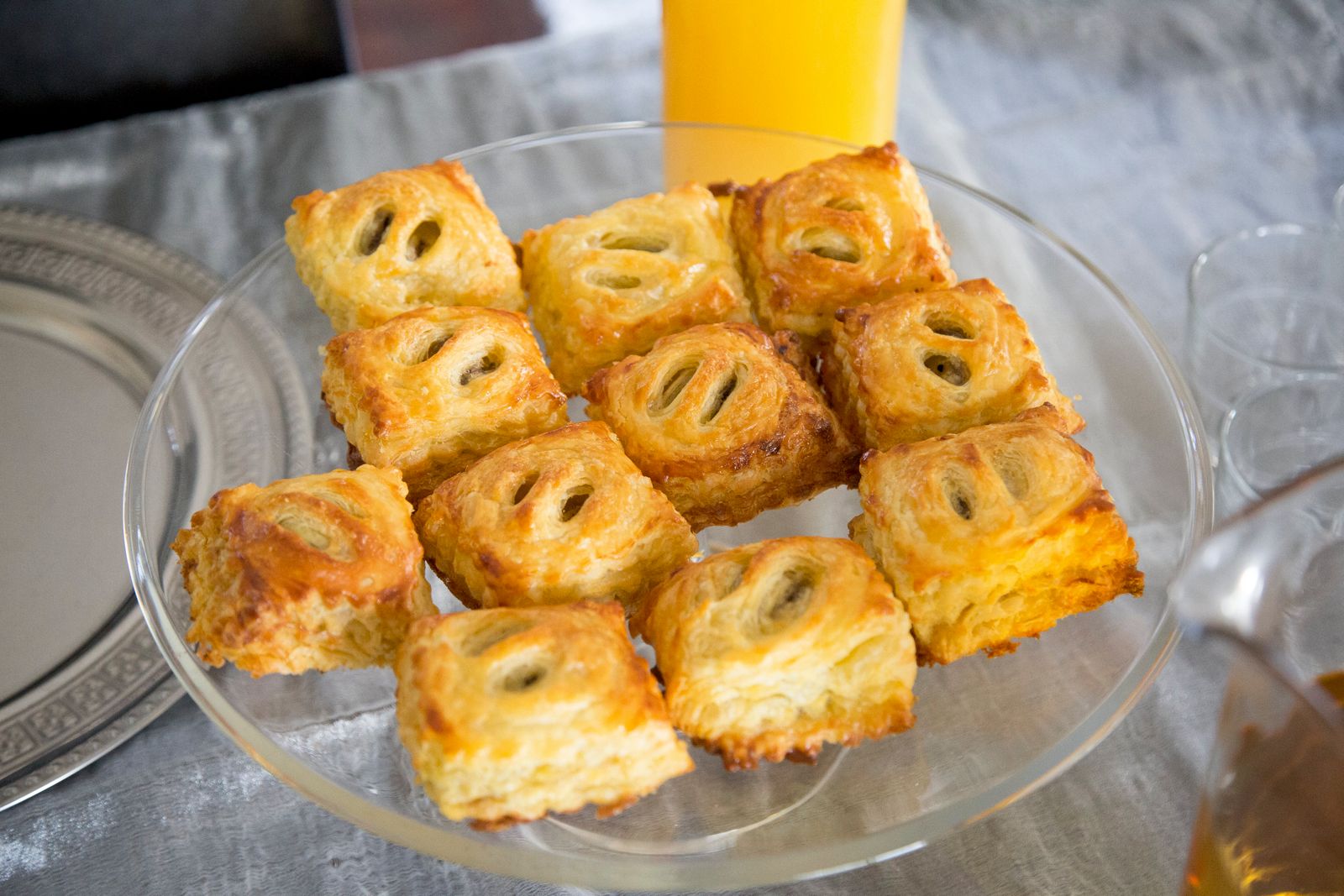 Flaky puff pastry squares on a glass plate