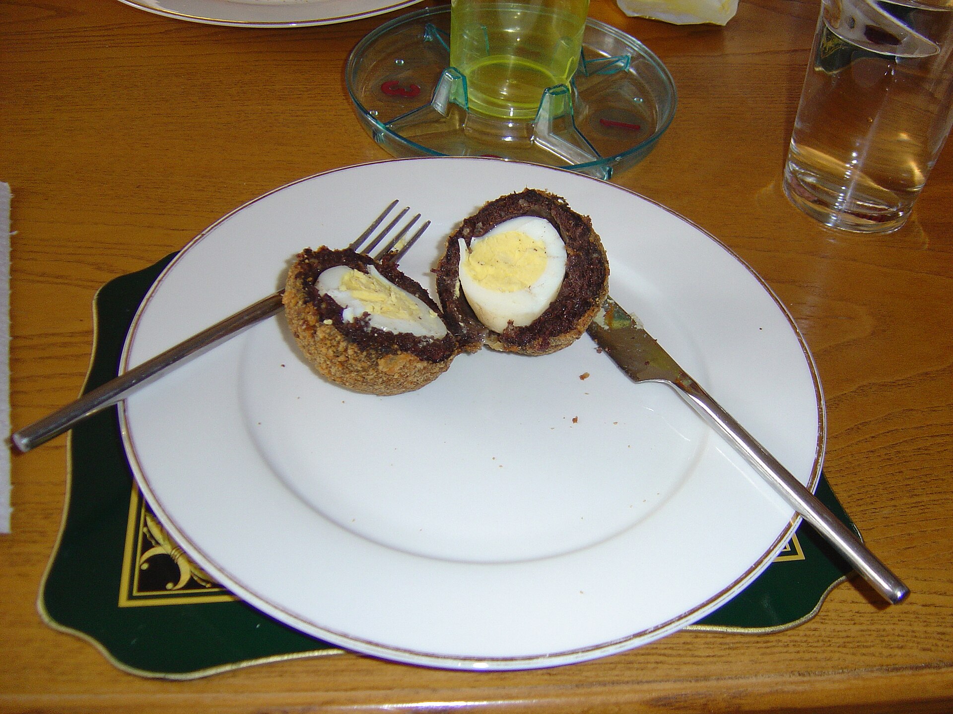 Scotch egg cut in half on a plate, classic Paul Hollywood party food