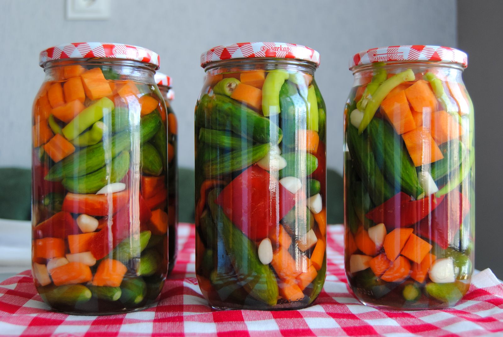 Glass jars of homemade pickles and preserved vegetables