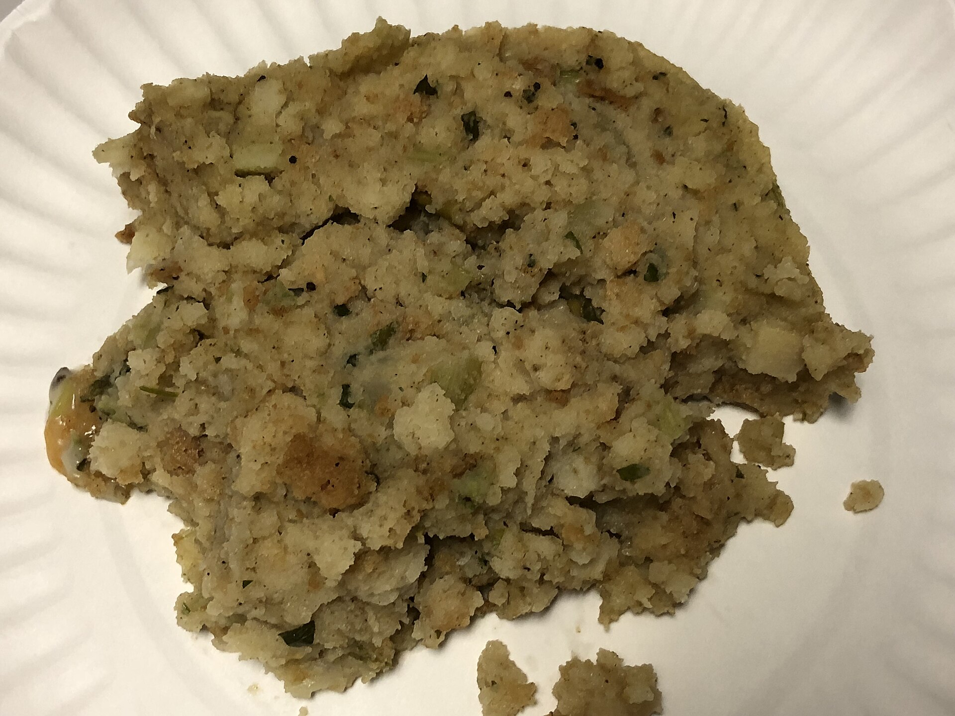 Herb bread stuffing on a white plate