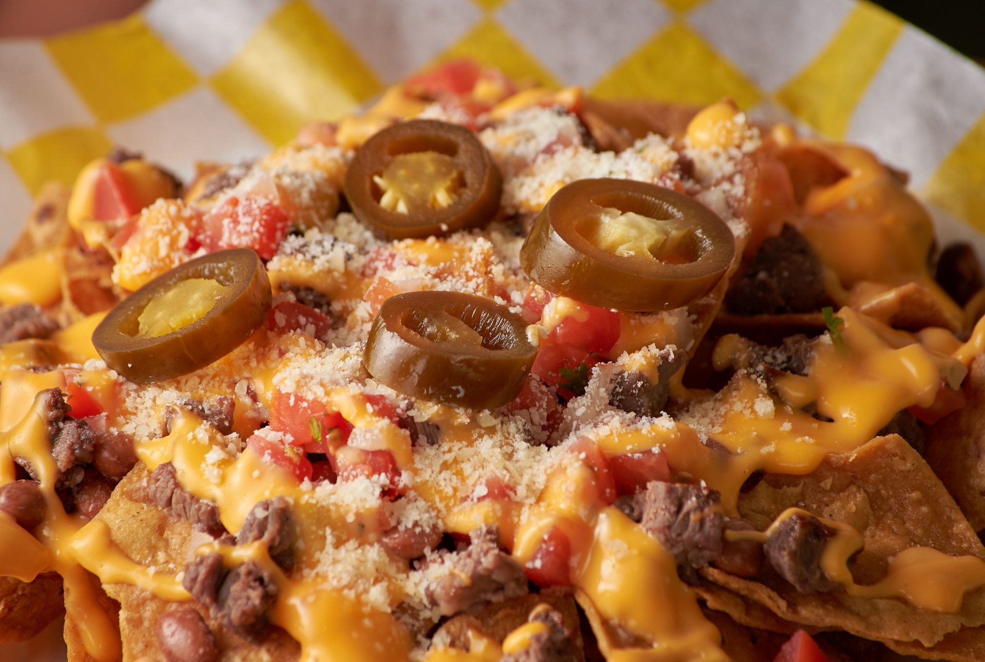 Loaded nachos with melted cheese, beef and sliced jalapenos