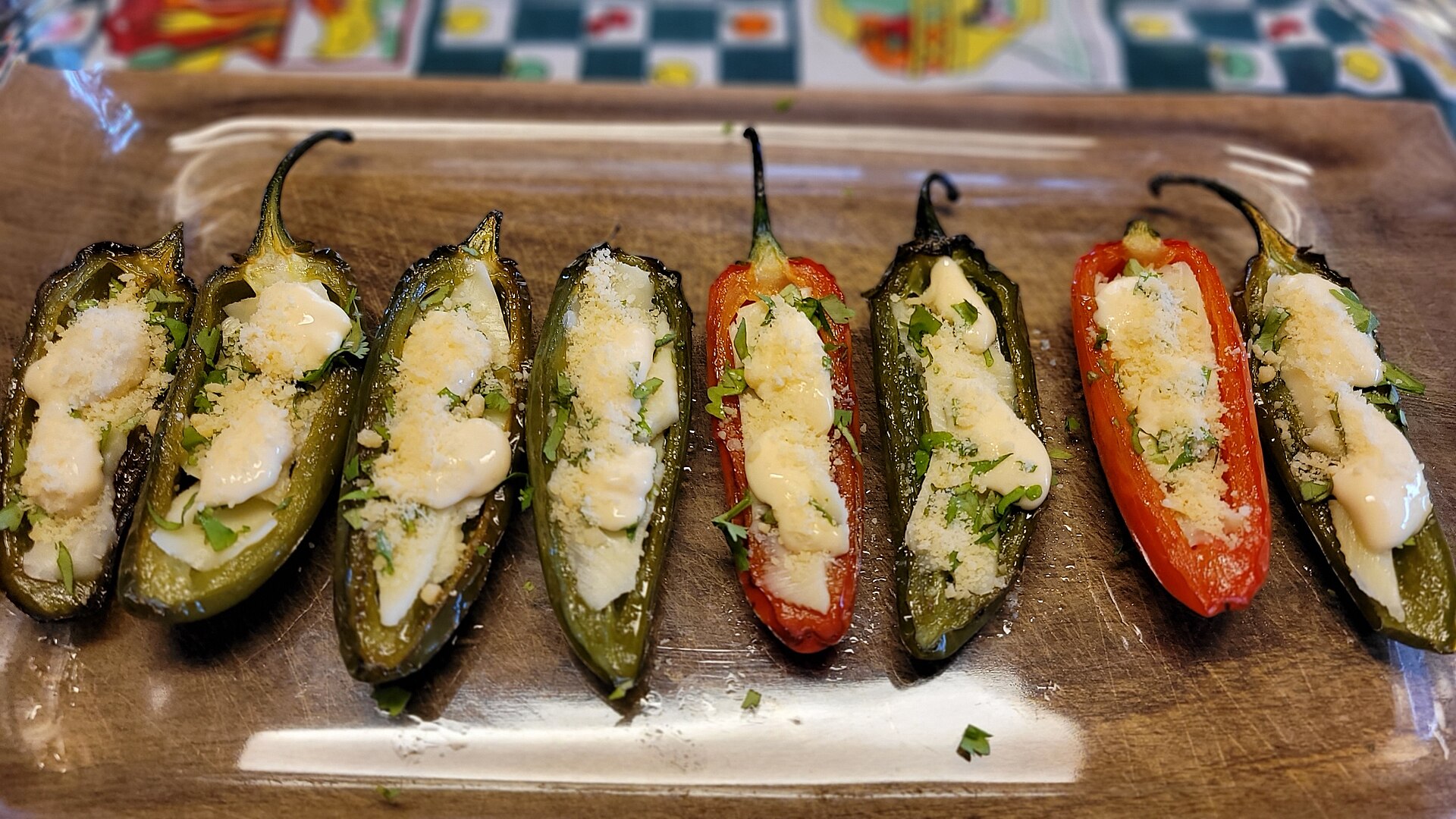 Jalapeno popper recipes: baked cream cheese stuffed jalapenos on a wooden tray