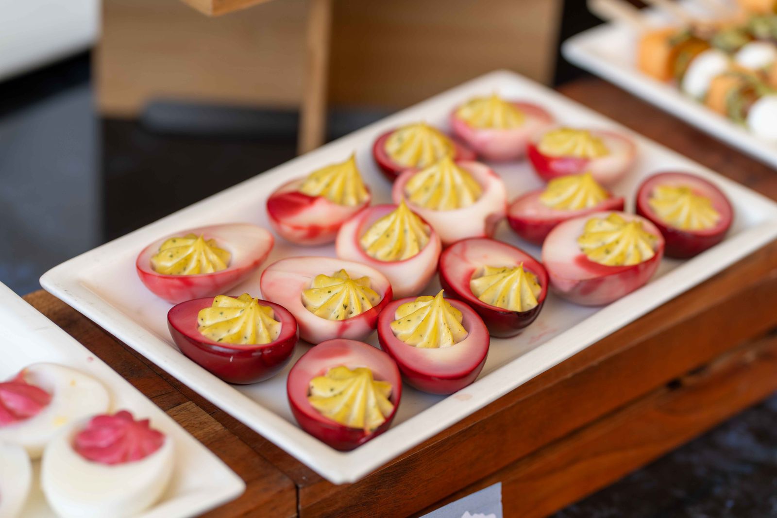 Colorful pink deviled eggs on a buffet tray