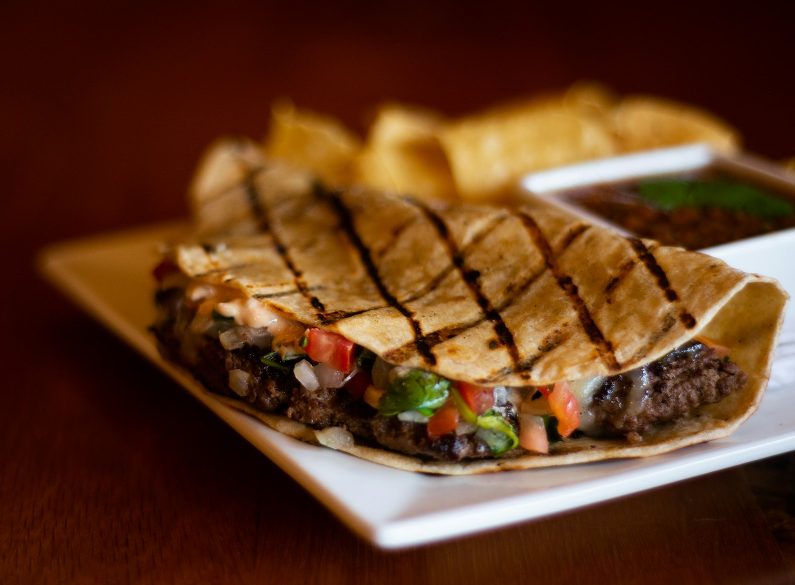 Toasted folded tortilla with grill marks and a hearty filling