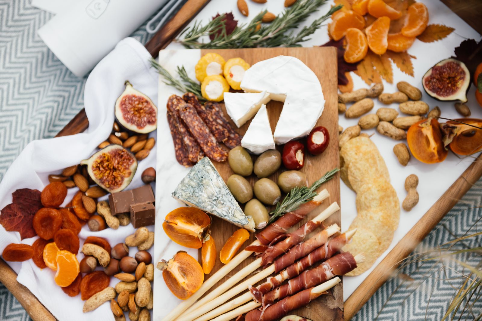 A big board of Thanksgiving appetizers with meats, cheese and fruit