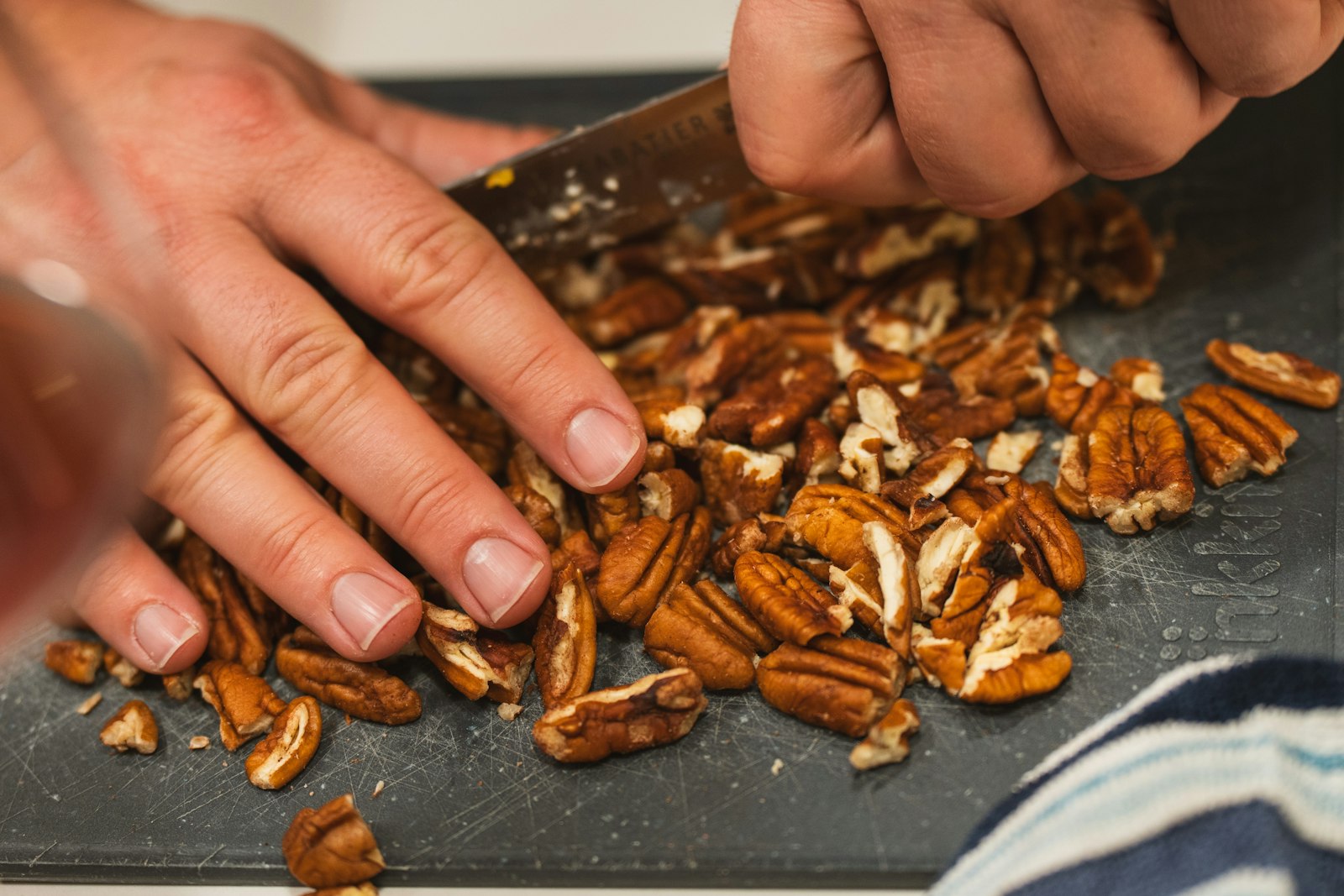 Chopping pecans on a board
