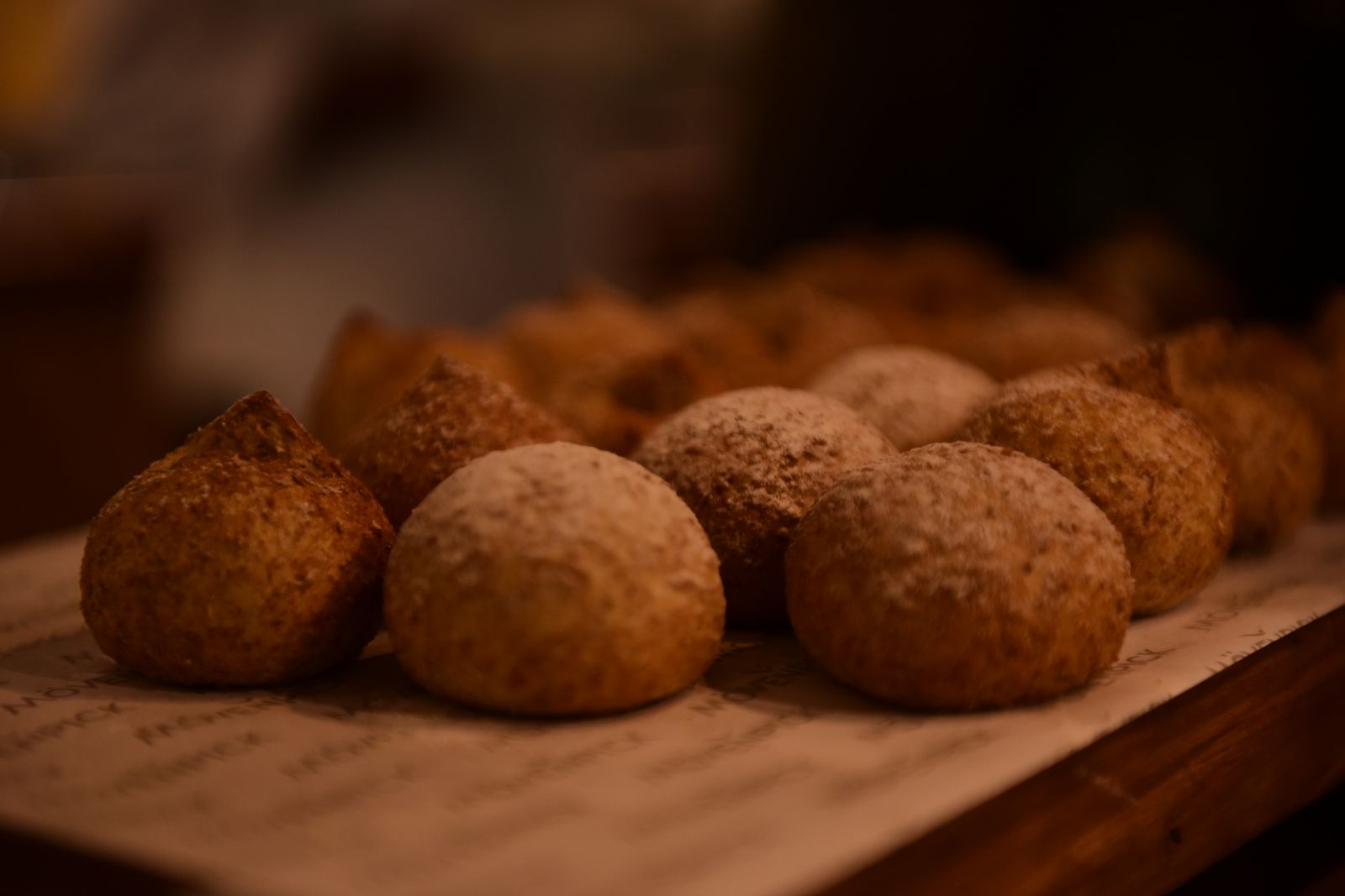 Golden baked savory balls on a wooden board
